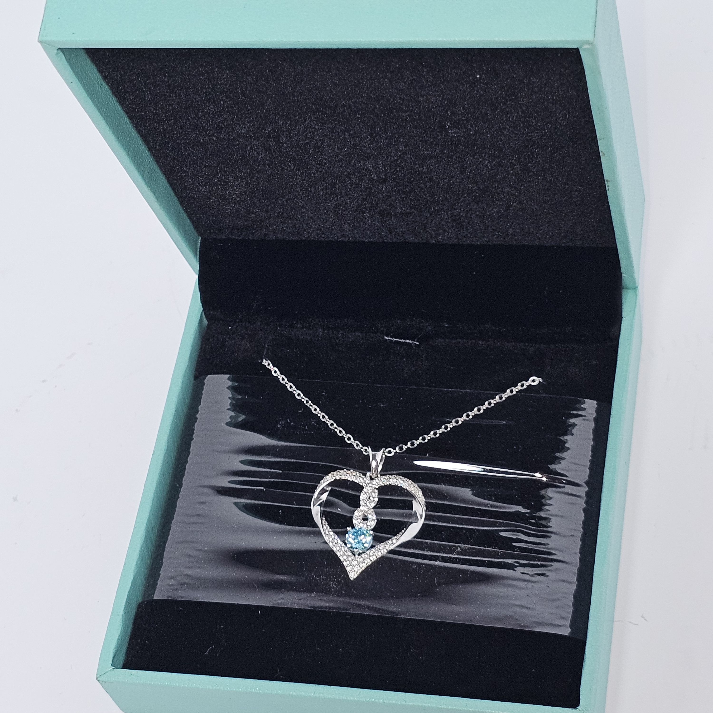 Elegant Silver Heart Necklace With Blue Accents